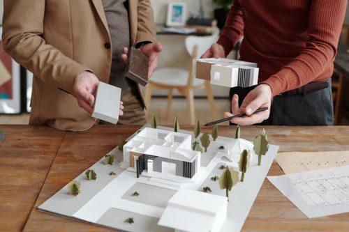 [fpdl.in]_hands-young-male-architect-pointing-model-new-house-that-his-mature-colleague-choosing-suitable-block-construction_274679-18747_large